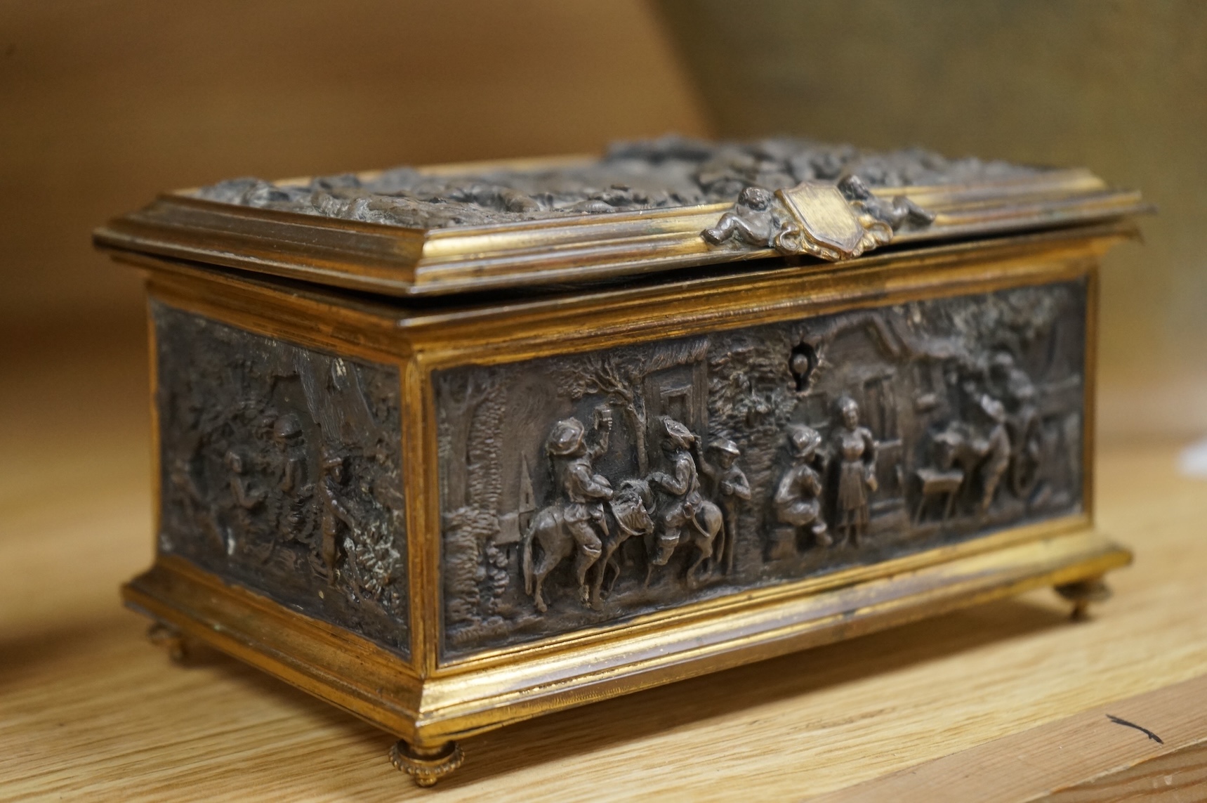 A late 19th century French gilt copper jewellery casket with electrotype relief panels, stamped A B Paris to the base, with key, 14cm wide